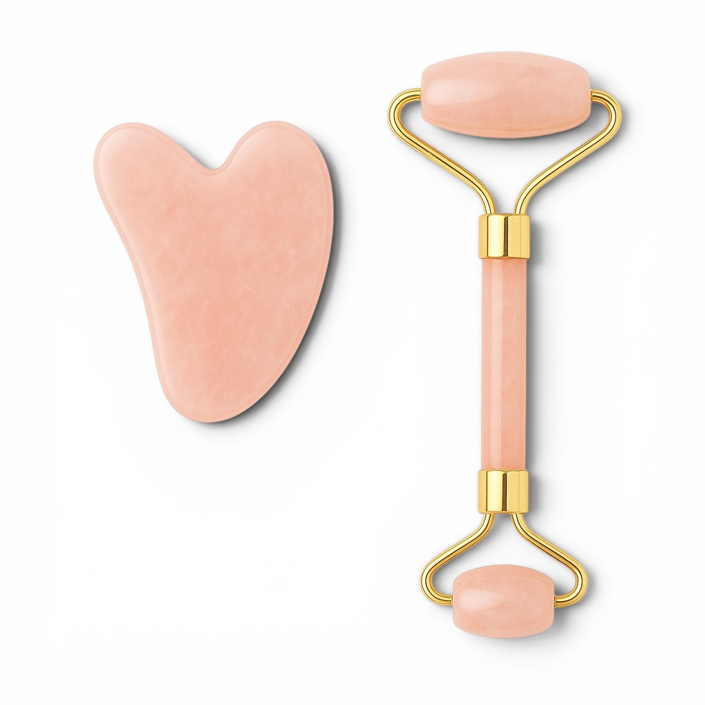 Pink facial roller and gua sha tool on a white background