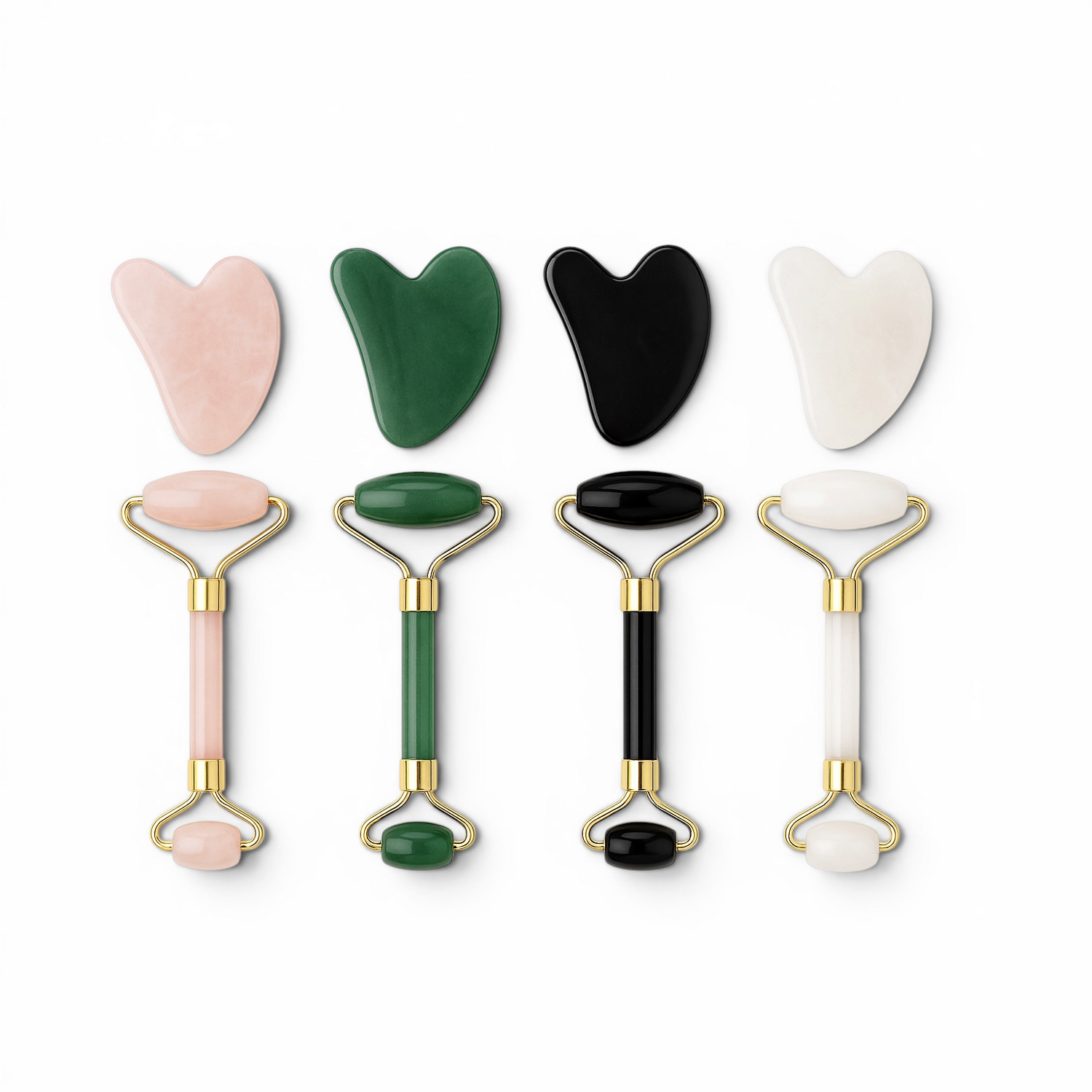 Set of facial tools including gua sha tools and rollers on a white background