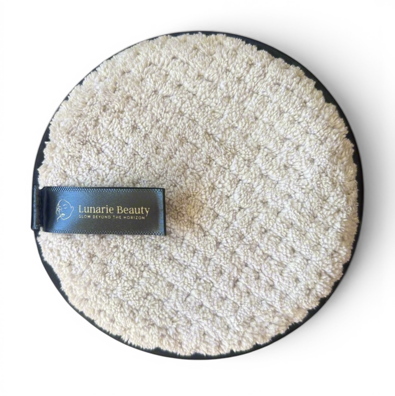 Round grey makeup remover sad product with a black border and 'Lunarie Beauty' label on a ligh gray background