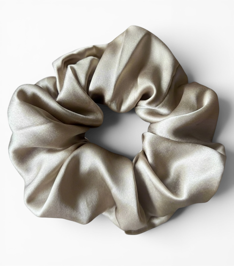 Beige silk scrunchie on a white background