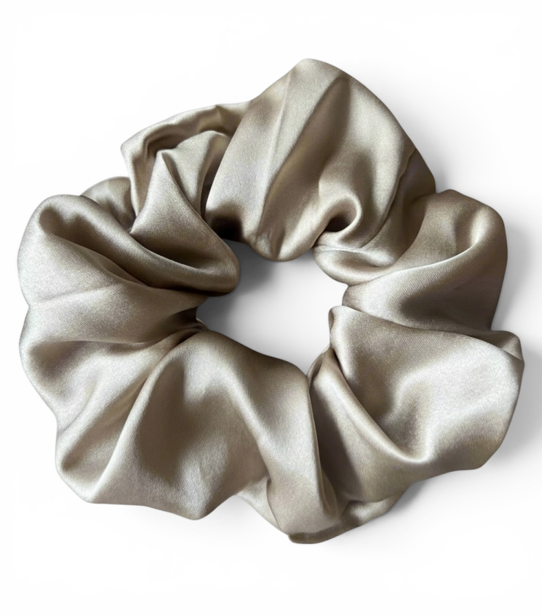 Gold silk scrunchie on a white background